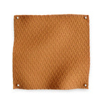 Wool trellis jacquard swatch pinned in all corners in rust orange