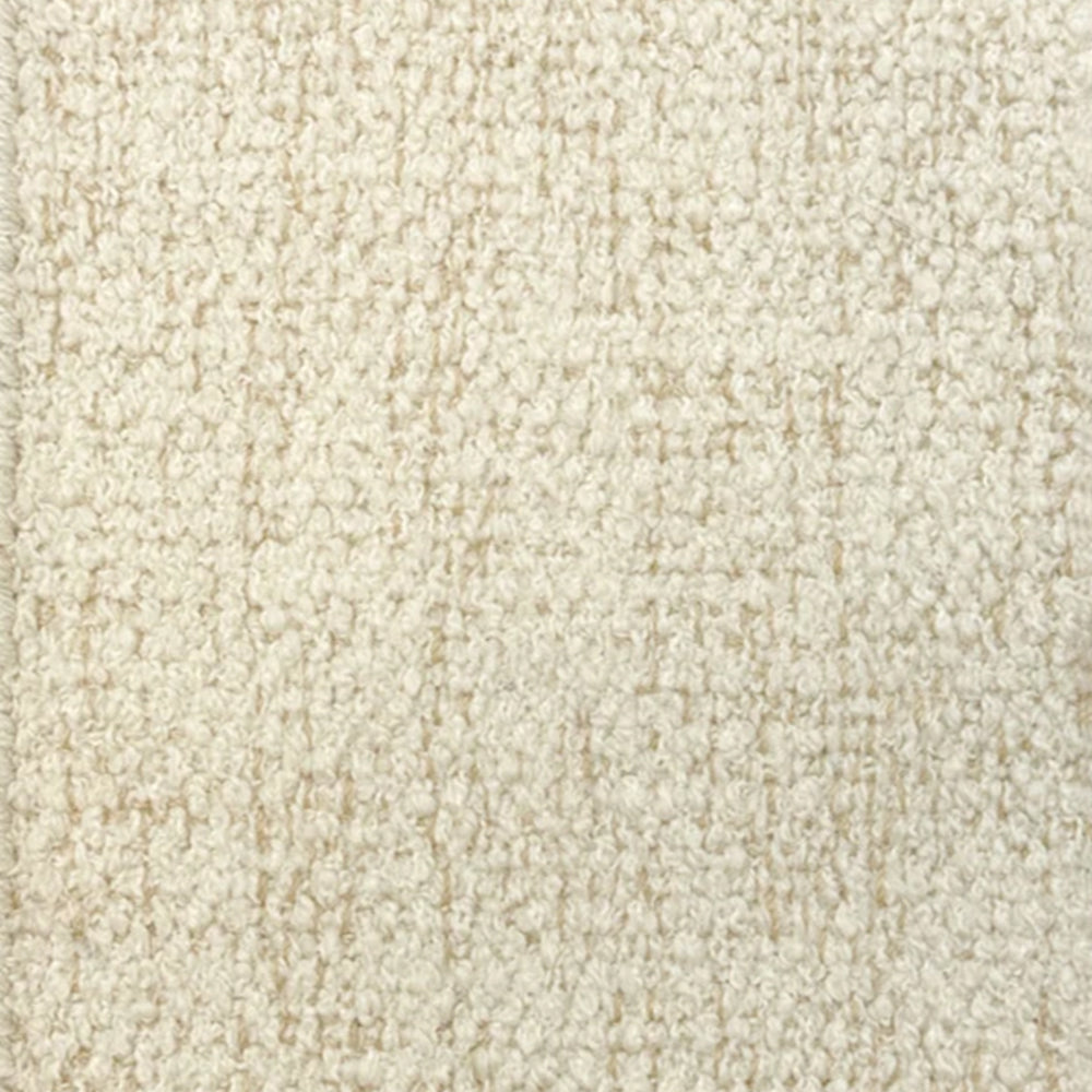 Broadloom carpet in cream bouclé with tan accents. 