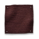 Wool boucle swatch pinned in all corners in wine red