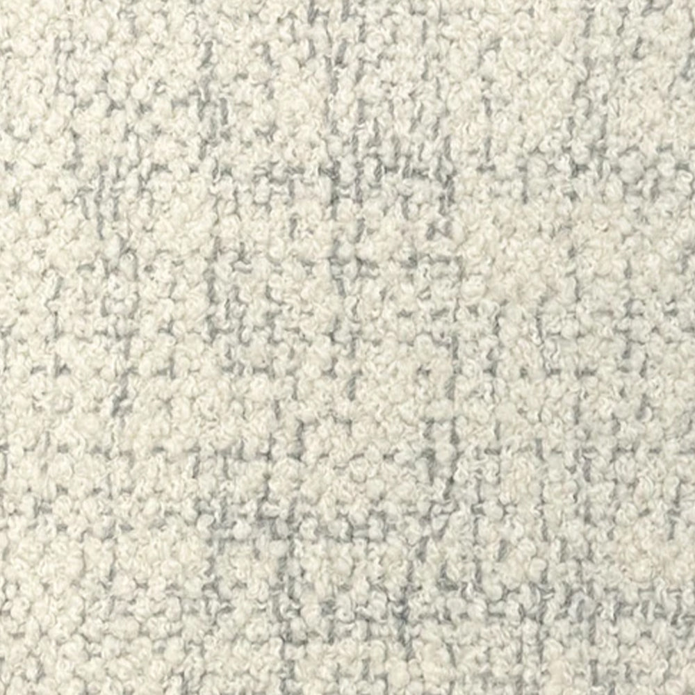 Broadloom carpet in cream bouclé with grey accents. 
