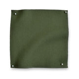 Wool sateen swatch pinned in all corners in moss green