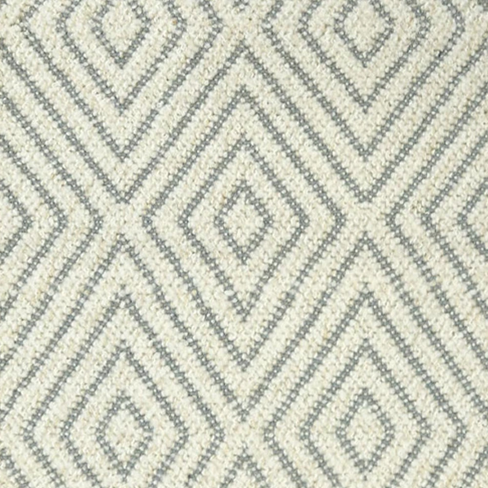 Broadloom carpet with dimensional diamond pattern in cream with grey.