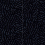 Wallpaper panels in a playful broken stripe print in black on a navy field.