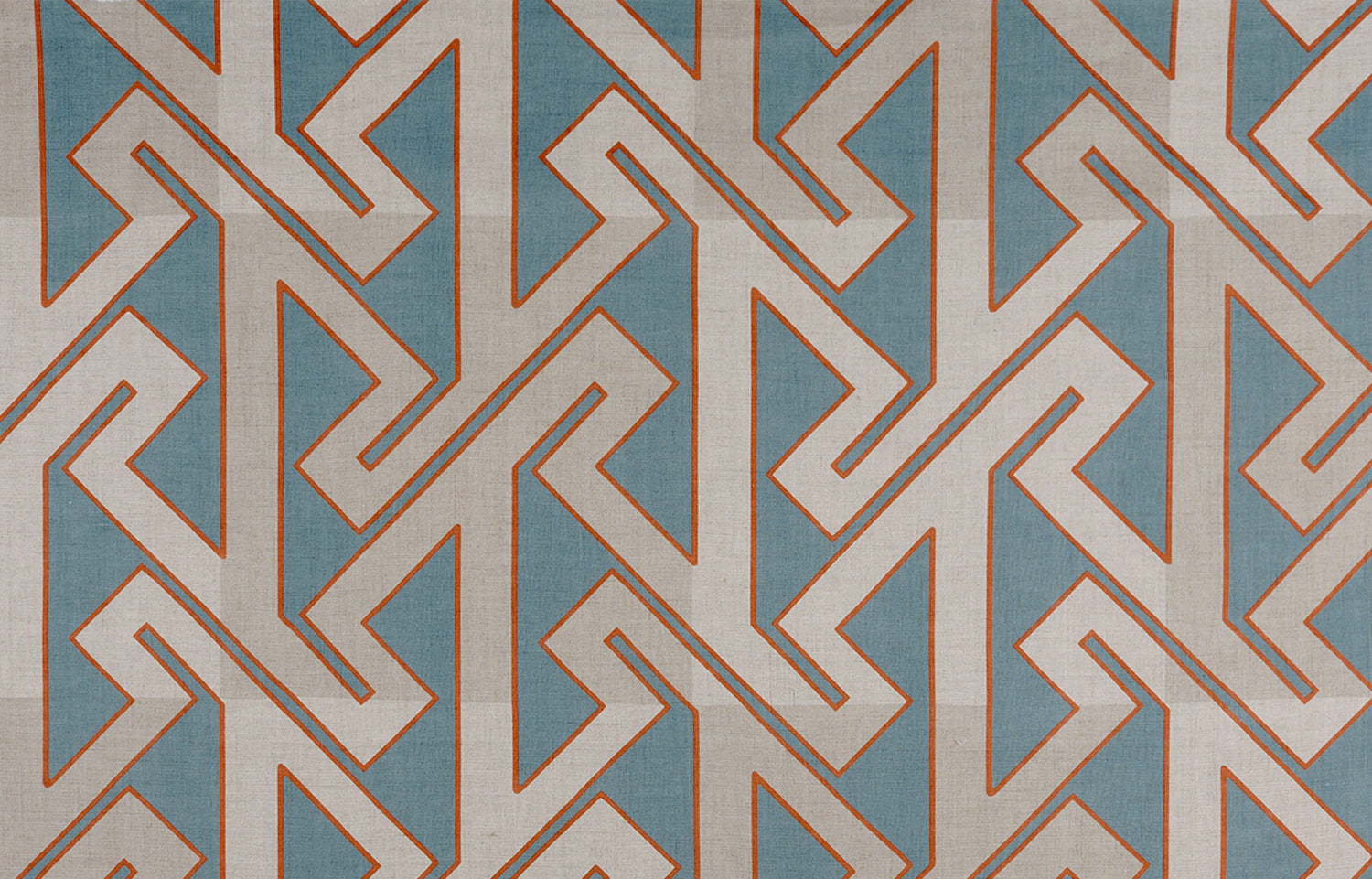 Detail of fabric in a contemporary lattice print in red and gray on a blue field.