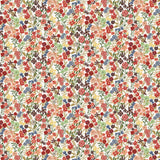 Detail of fabric in a dense small-scale floral print in shades of coral, red, green and blue on a white field.