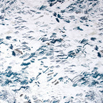 Detail of wallpaper in a painterly seaside print in shades of blue and gray on a white field.