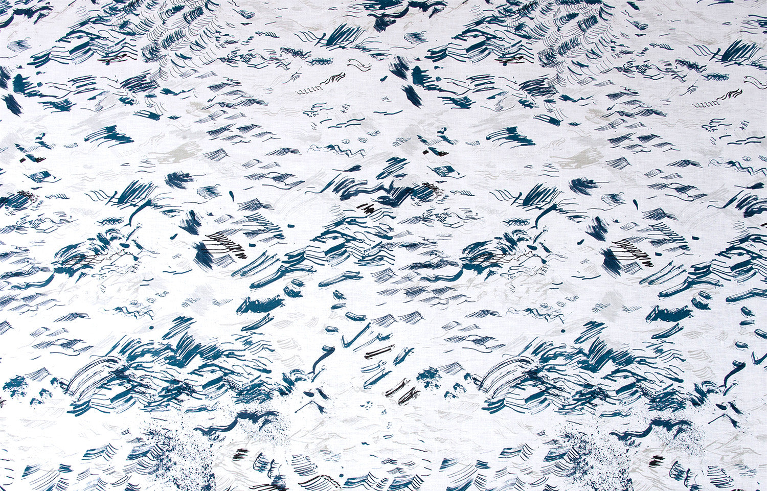 Detail of wallpaper in a painterly seaside print in shades of blue and gray on a white field.