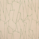 Detail of fabric in an abstract lattice print in green on a tan field.
