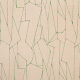 Detail of fabric in an abstract lattice print in green on a tan field.