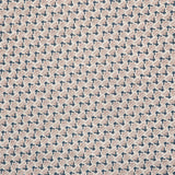 Detail of fabric in a dense geometric print in navy, tan and cream.