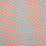 Detail of fabric in a dense geometric print in red, blue and cream.