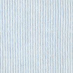 Detail of fabric in a wiggly stripe print in blue on a white field.