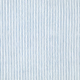 Detail of fabric in a wiggly stripe print in blue on a white field.