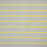 Detail of fabric in a horizontal striped print in yellow and white on a tan field.