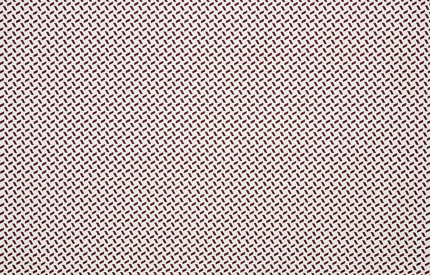 Detail of fabric in a small-scale geometric grid print in brown on a white field.