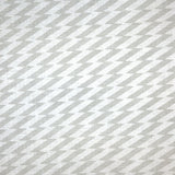 Detail of fabric in a zigzag stripe print in gray on a white field.