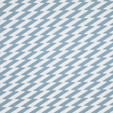 Detail of fabric in a zigzag stripe print in blue-gray on a white field.