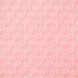 Detail of fabric in a diamond lattice print in white on a pink field.