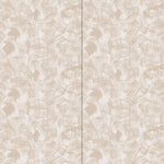 Wallpaper in an abstract paint swatch print in tan on a cream field.
