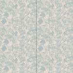 Wallpaper in an abstract paint swatch print in light blue on a tan field.