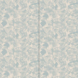 Wallpaper in an abstract paint swatch print in light blue on a tan field.