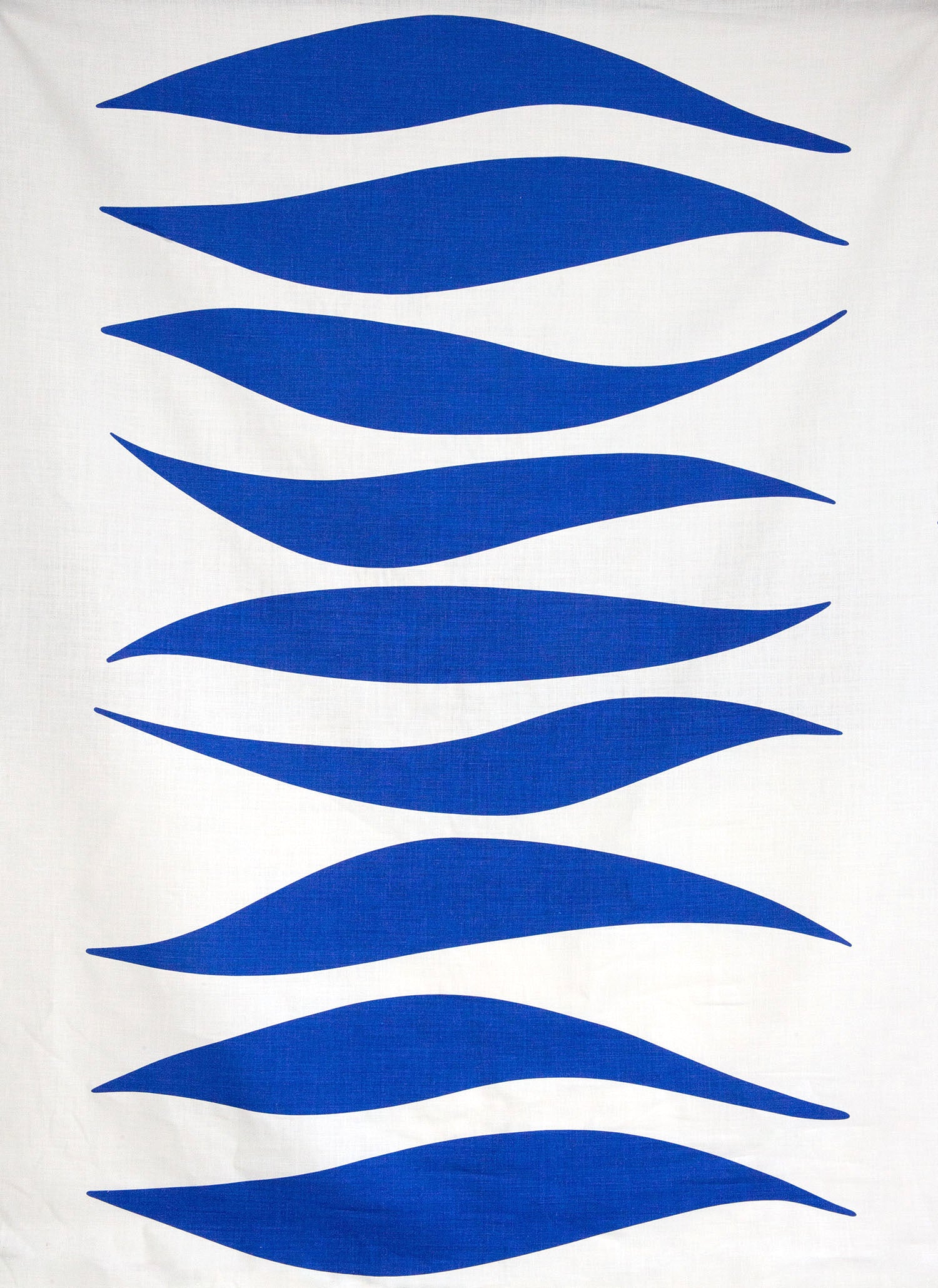 Detail of fabric in an abstract wave print in blue on a white field.
