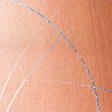 Wide-angle shot of wallpaper in an abstract curved line pattern in metallic silver on an orange field.