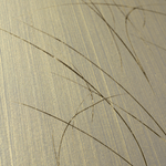 Wide-angle shot of wallpaper in an abstract curved line pattern in gold on a metallic field.