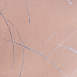 Detail of a wallpaper in an abstract curved line pattern in metallic silver on a pink field.