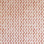 Detail of wallpaper in a playful curvy stripe print in red on a cream field.
