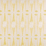 Detail of fabric in an abstract geometric print in yellow and white.