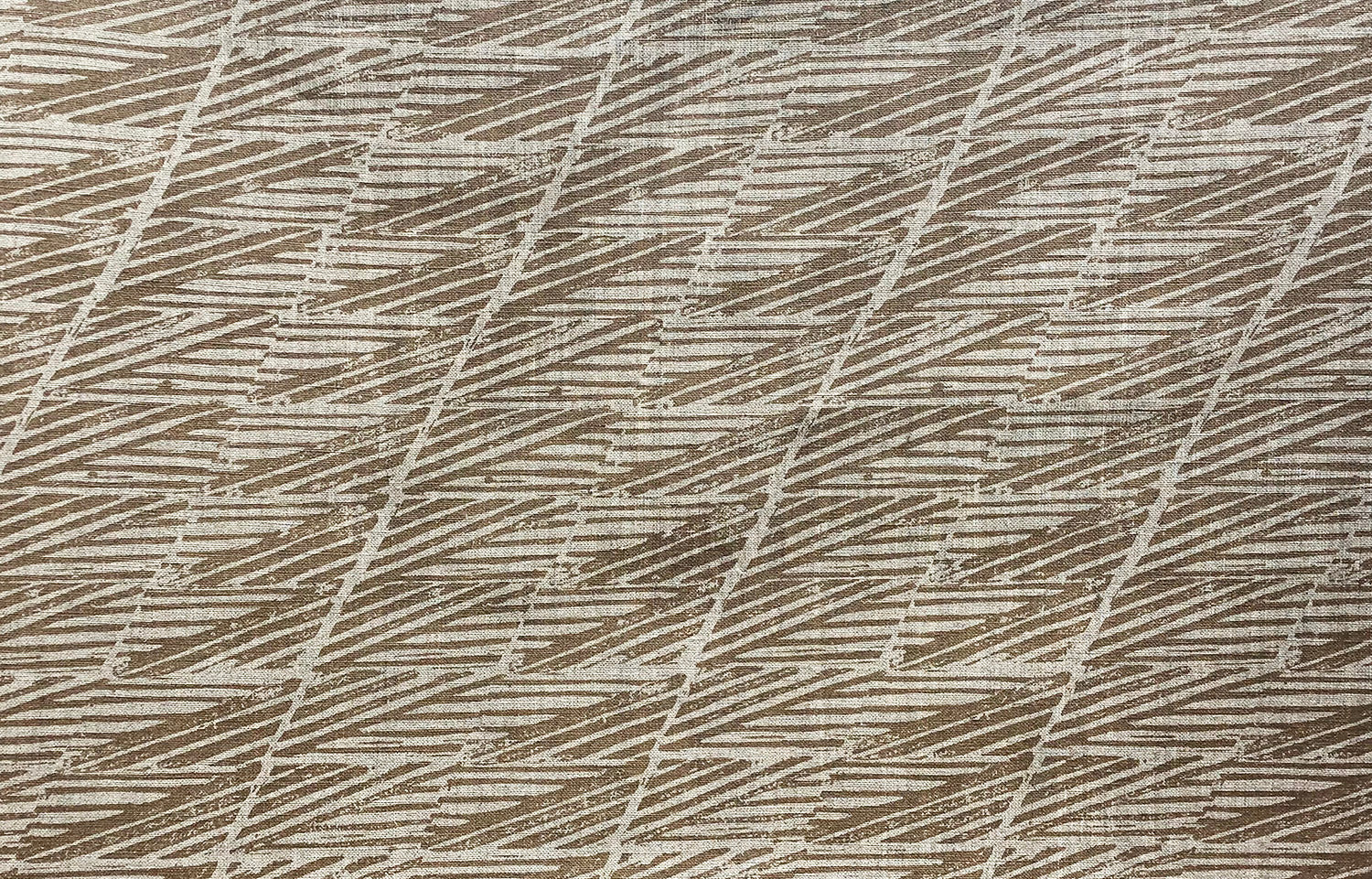 Detail of fabric in a textural geometric stripe in shades of brown.