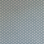 Detail of wallpaper in a minimalist quatrefoil pattern in gray on a blue field.