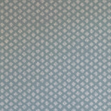 Detail of wallpaper in a minimalist quatrefoil pattern in gray on a blue field.