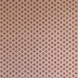 Detail of wallpaper in a minimalist quatrefoil pattern in red on a cream field.