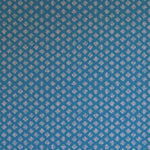 Detail of wallpaper in a minimalist quatrefoil pattern in light pink on a blue field.