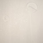 Detail of a wallpaper in a paint splatter print in metallic cream on a cream field.