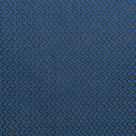 Detail of fabric in a playful curving stripe in gray on a navy field.
