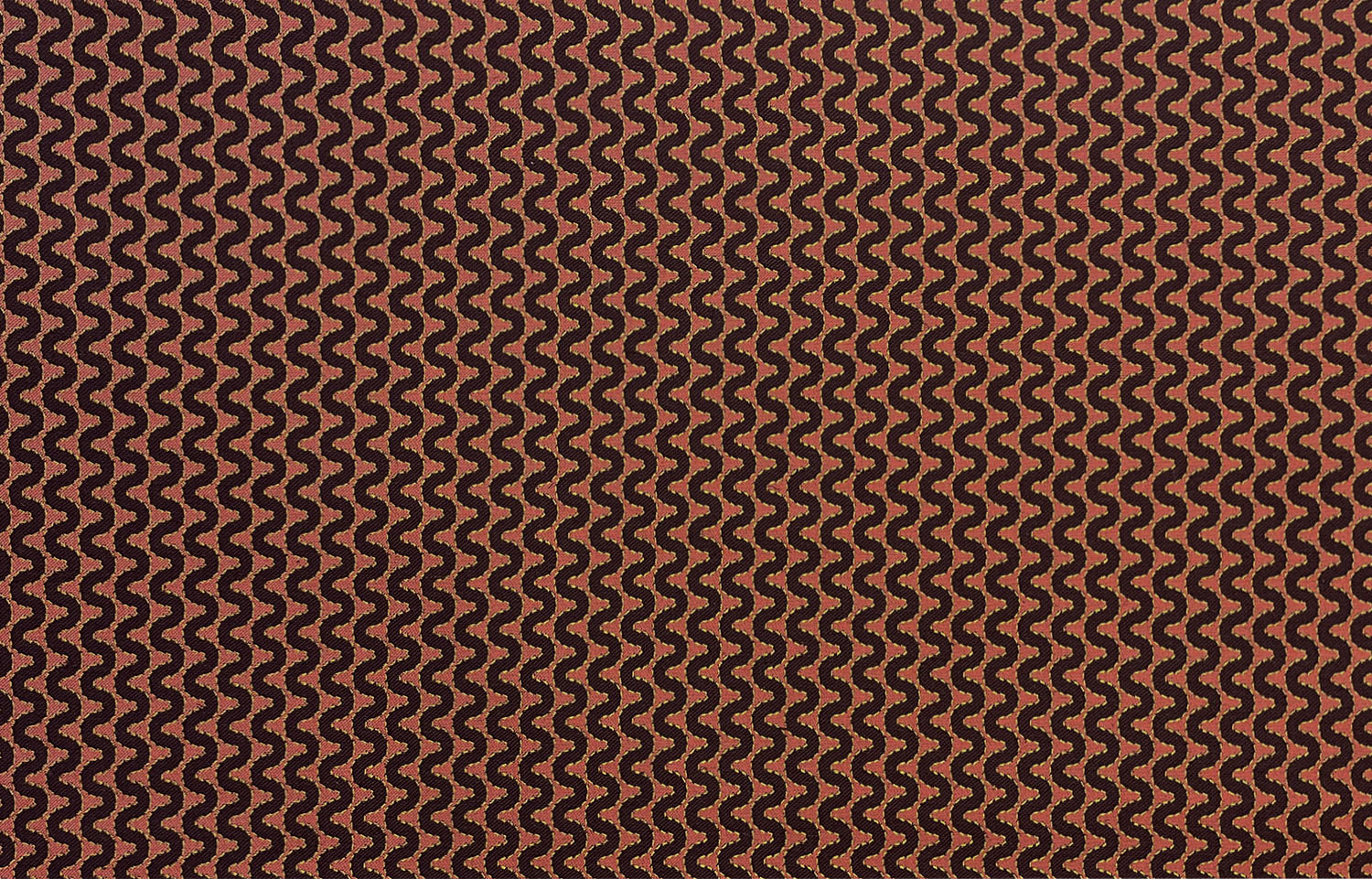 Detail of fabric in a playful curving stripe in black on a burnt orange field.