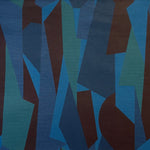 Detail of fabric in an abstract geometric print in blue, green and brown.