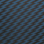 Detail of fabric in a zigzag stripe print in navy on a black field.