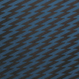 Detail of fabric in a zigzag stripe print in navy on a black field.