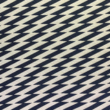 Detail of fabric in a zigzag stripe print in black on a cream field.