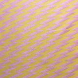 Detail of fabric in a zigzag stripe print in pink on a mustard field.