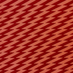 Detail of fabric in a zigzag stripe print in red on a burnt orange field.