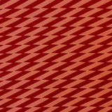 Detail of fabric in a zigzag stripe print in red on a burnt orange field.