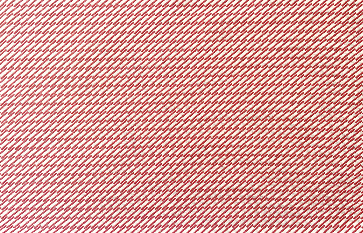 Detail of fabric in a matchstick grid print in red on a white field.