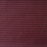 Detail of fabric in a matchstick grid print in black on a red field.