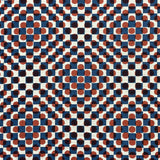 Detail of fabric in a geometric check and polka dot pattern in burnt orange, blue, cream and black.