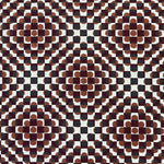 Detail of fabric in a geometric check and polka dot pattern in burnt orange, green, cream and black.